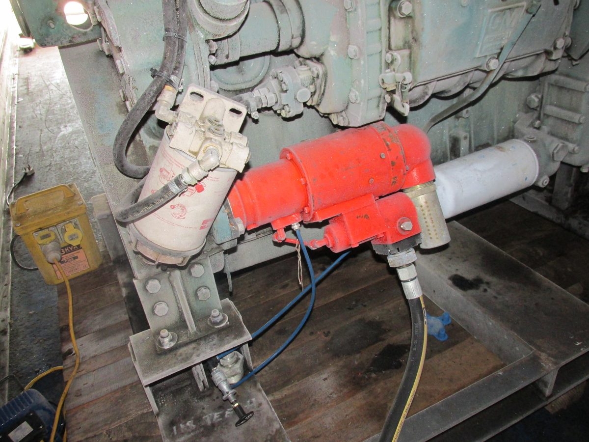 Red Powerstart air starter motor mounted on an industrial diesel engine with air line and inline filter