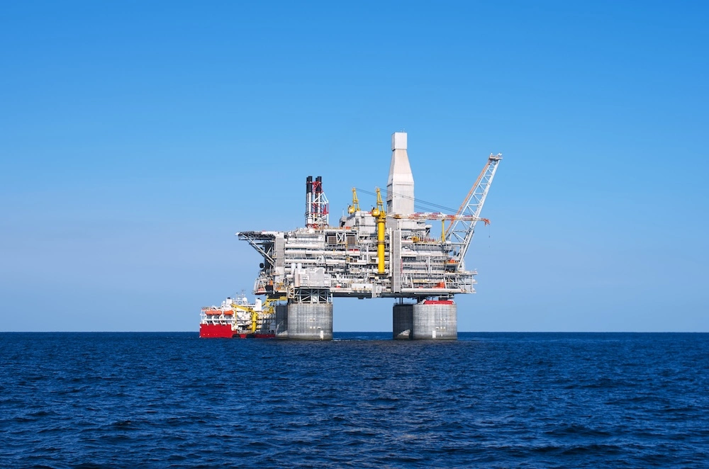 Offshore production platform with a supply vessel alongside, a classified hazardous area