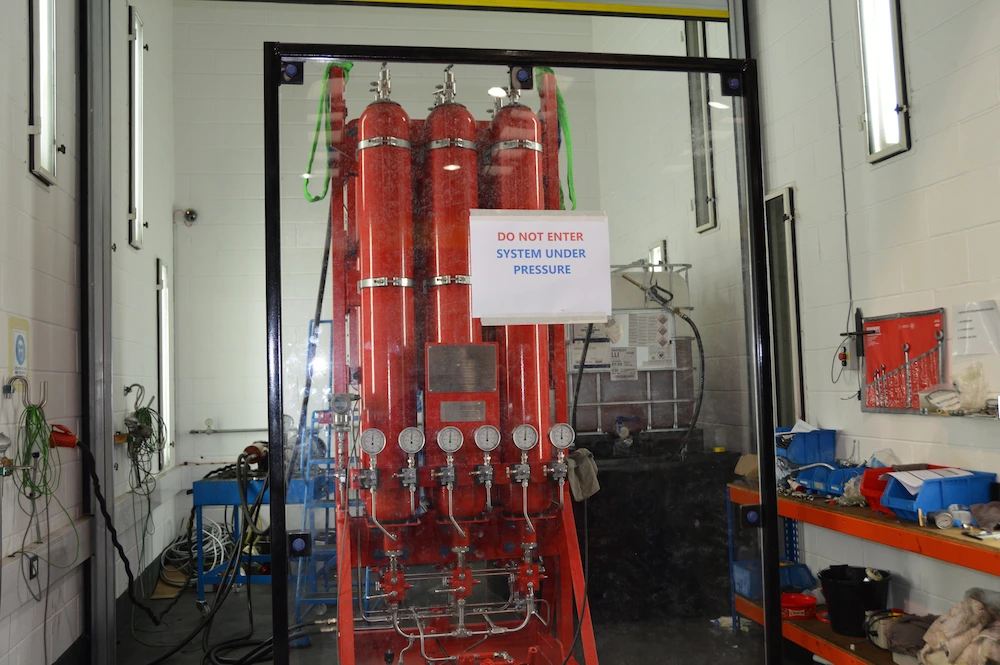 Powerstart starting system undergoing pressure testing behind safety glass